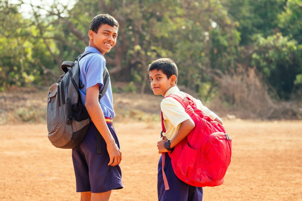 two indian brothers going to school in Goa outdoors